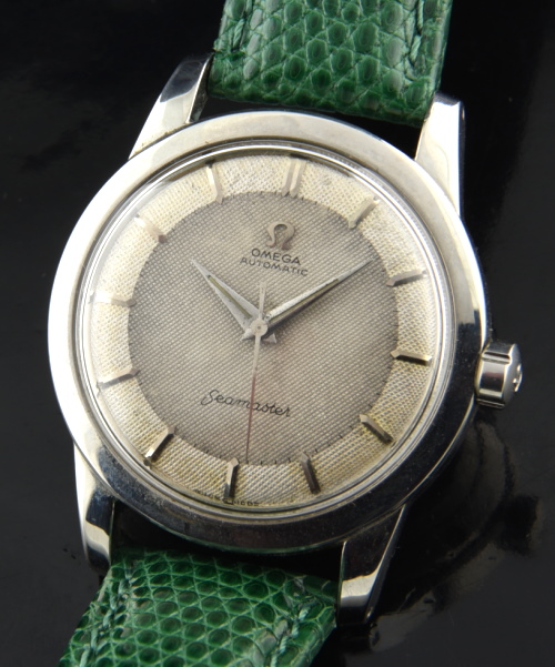 1950 Omega Seamaster stainless steel watch with original waffle dial, Dauphine hands, case, winding crown, and bumper automatic movement.