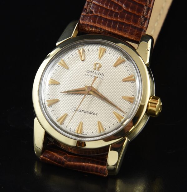 1957 Omega Seamaster gold-capped watch with original honeycomb dial, Dauphine hands, and cleaned caliber 471 automatic winding movement.