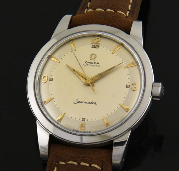 1951 Omega 36.5mm seamaster stainless steel watch with original winding crown, dial, gold-toned markers, and caliber 351 bumper movement.
