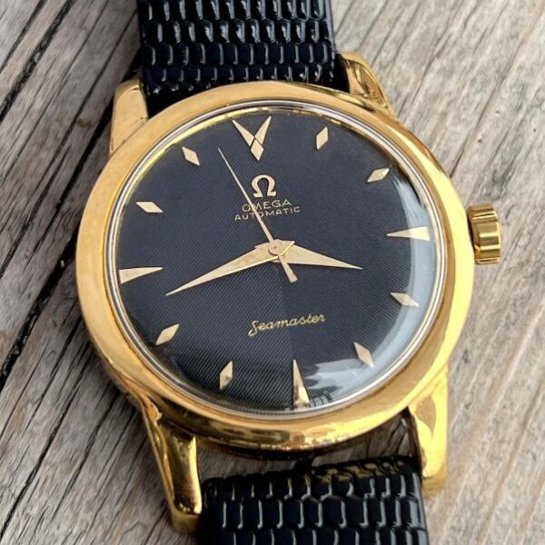 1952 Omega Seamaster 34.5mm watch with ribbed original gold gilt printed black dial, diamond and arrow markers, and automatic caliber 354.