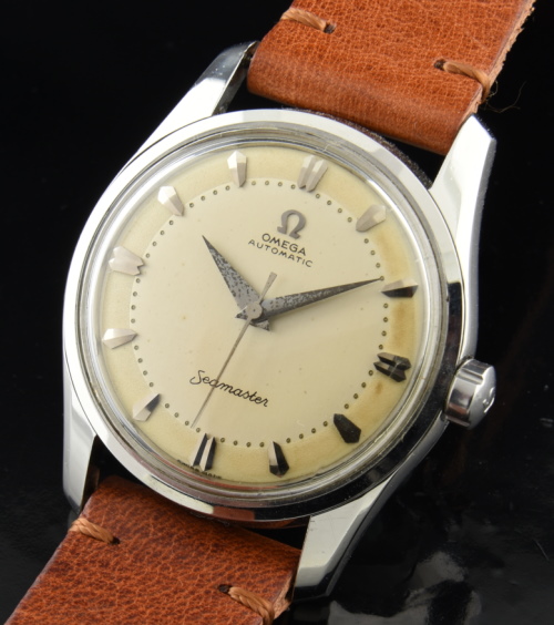 1956 Omega 34mm Seamaster stainless steel watch with original two-toned dial, markers, Dauphine hands, and caliber 501 automatic movement.