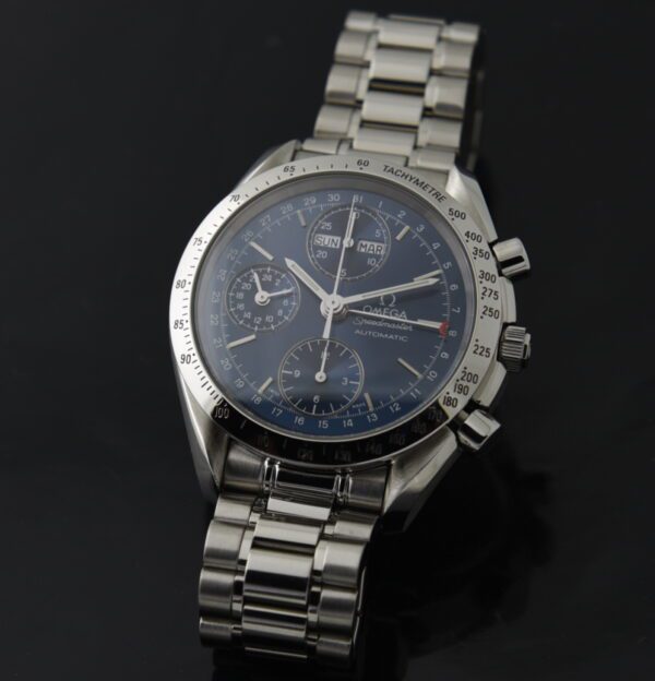 1995 Omega 39mm Speedmaster Triple Date stainless steel chronograph watch with original case, serviced caliber 1151 movement, and blue dial.