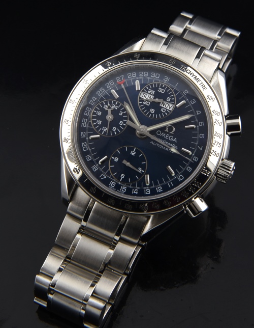 1995 Omega Speedmaster Triple Date stainless steel chronograph watch with original crystal, bracelet, blue dial, and caliber 1151 movement.