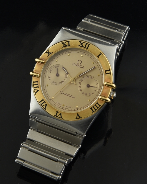 1989 Omega Constellation stainless steel and gold watch with original bracelet, papers, day/date displays, and high-quality quartz movement.
