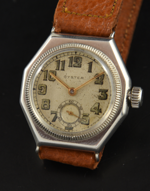 1920s Rolex 31mm Oyster sterling silver watch with original three-piece case, reed bezel, radium dial, crown, and manual winding movement.