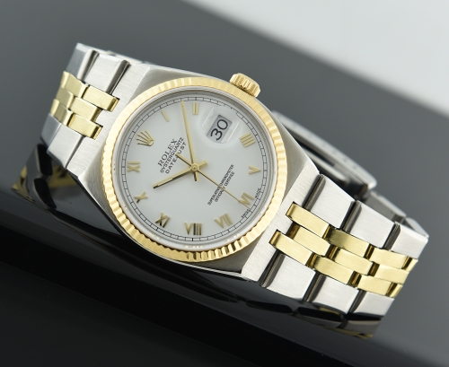 1980 Rolex Oysterquartz Datejust gold and steel watch with original case, bracelet, quick-set date feature, and electronic quartz movement.