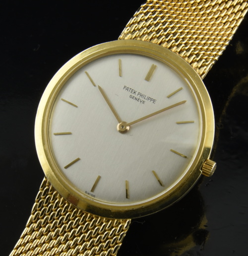 1980s Patek Philippe 32mm solid-gold watch with original bracelet, buckle, dial, hands, case, winding crown, and manual winding movement.