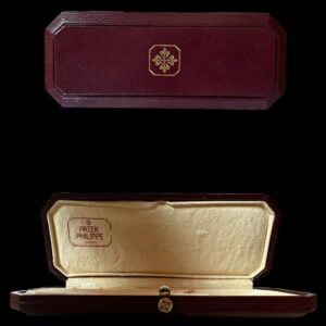 1990s Patek Philippe coffin-shaped mens watch box measuring 2.5x6" with original inner box and outer cardboard/leatherette box.