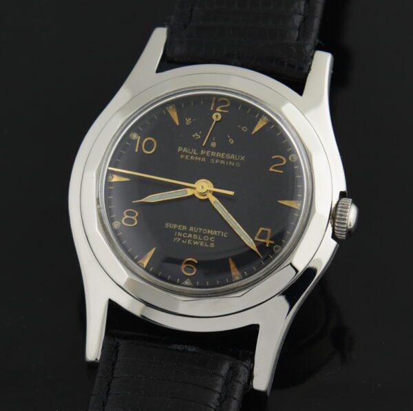 1950s Paul Perregaux 33.5mm stainless steel watch with original case, angled bezel, black dial, power reserve indicator, and extended lugs.