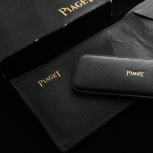 Uncommon and unused high quality Piaget leather wallet with a pen knife holder, original box, and in pristine quality.