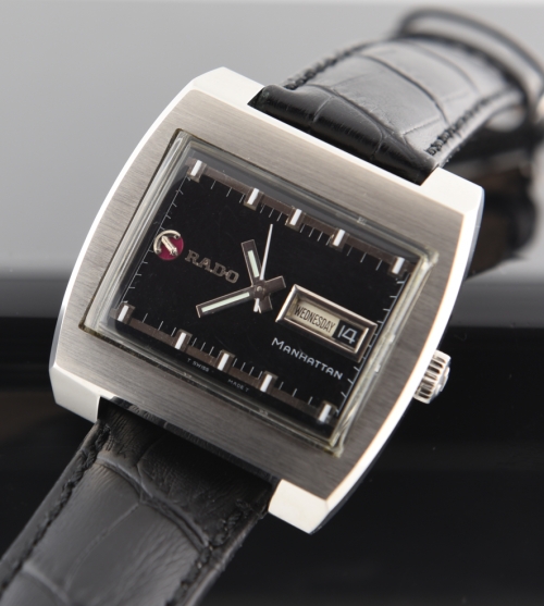 1970s Rado Manhattan stainless steel watch with original restored black dial, chunky markers, baton hands, day/date display, and anchor.