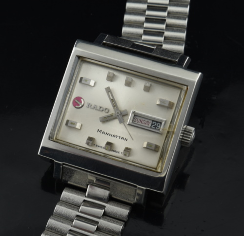 1970s Rado 34mm Mangattan stainless steel watch with original silver dial, crown, baton hands, NSA bracelet, and automatic winding movement.