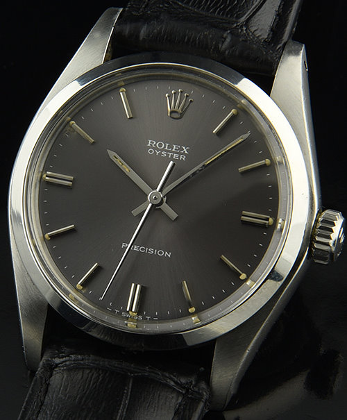 1981 Rolex Oyster stainless steel watch with original slate-grey dial, baton hands, markers, lume plots, case, and manual winding movement.