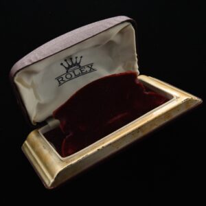 Rare 1940s Rolex watch box with silk, metal, velvet, and measuring 2.75x5.5".