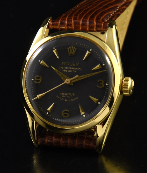 1956 Rolex Oyster Meritus gold-plated watch with original restored case, winding crown, Dauphine hands, and caliber 1030 butterfly movement.