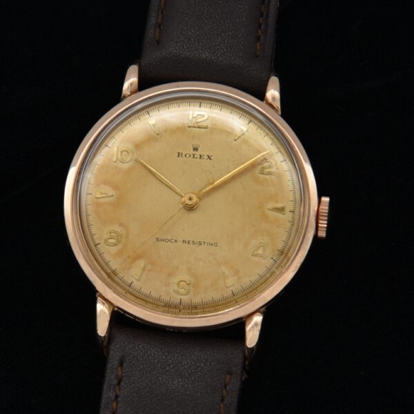 1950s Rolex 33.75mm solid 9k rose gold mens dress watch with original narrow bezel, all-dial appearance, hands, and manual winding movement.