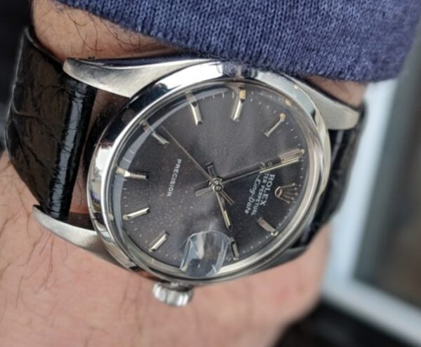 1977 Rolex 35mm Air-King Date stainless steel watch with original Oyster case, winding crown, slate grey dial, and caliber 1520 movement.