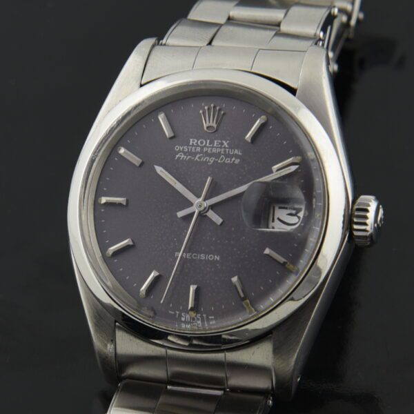 1977 Rolex 34mm Air-King Date stainless steel watch with original slate grey dial, lume plots, automatic movement, and 1976 Oyster bracelet.