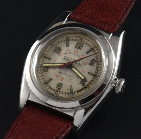 1940s Rolex 31mm flat-back Bubbleback Centergraph stainless steel watch with original case, dial, "chronometer" stamp, and manual movement.