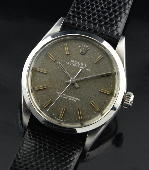 1969 Rolex Oyster Perpetual stainless steel watch with original sandy pebble dial, case, baton hands, and clean automatic winding movement.