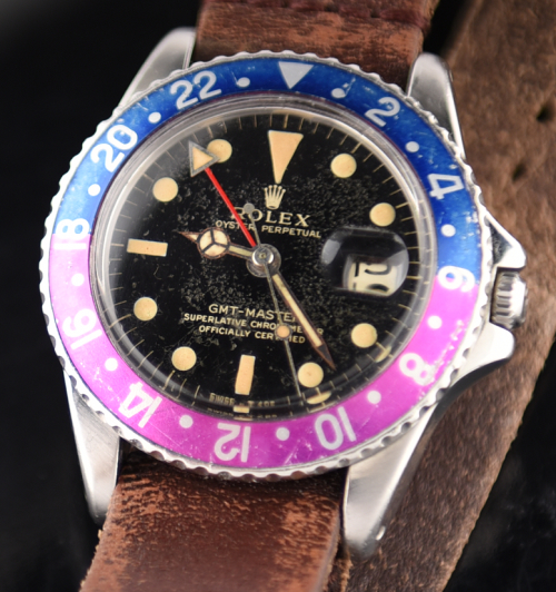 1966 Rolex GMT Master stainless steel watch with original gilt dial, deep-vanilla lume, case, replaced 24-hour hand, and automatic movement.