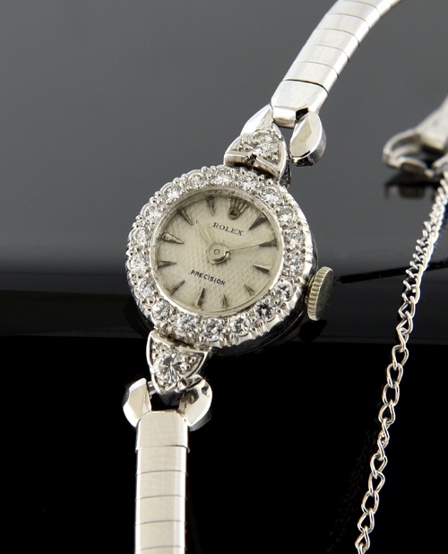1950s Rolex platinum ladies watch with original diamond case, white-gold-filled bracelet, honeycomb dial, and clean manual winding movement.