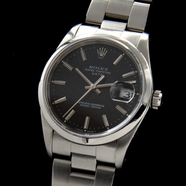 1987 Rolex 34mm Oyster Perpetual stainless steel watch with original black dial, sapphire crystal, caliber 3135, and quick-set date feature.
