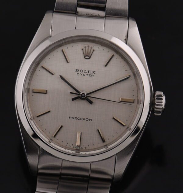 1971 Rolex 34mm Oyster Precision stainless steel watch with original linen dial, recently serviced manual winding movement, and bracelet.