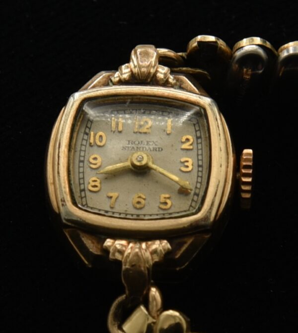 1940s Rolex Standard gold-filled ladies cocktail watch with original case, glass crystal, stretch bracelet, and manual winding movement.