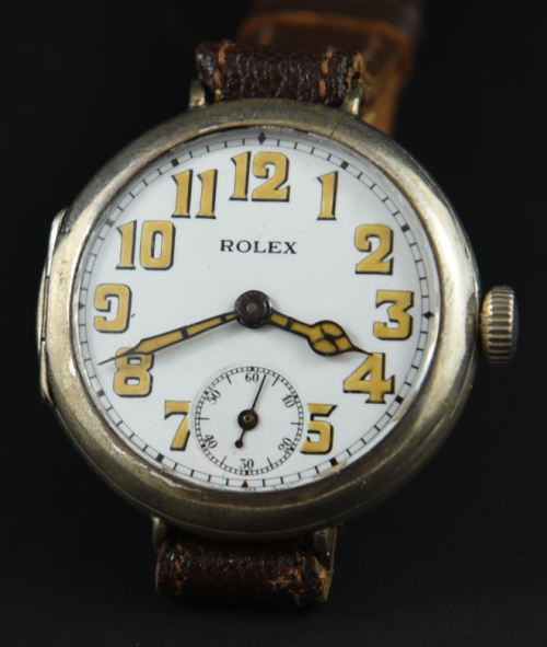 1914 Rolex 34mm sterling silver WW1-era trench watch with original hinged case, dial, cathedral-style hands, and manual winding movement.