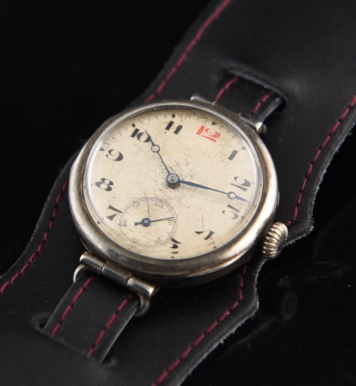 1915 Rolex 33.75mm sterling silver trench watch with original case, onion winding crown, custom leather band, and cleaned manual movement.