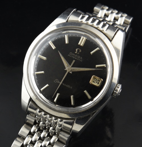 1966 Omega Seamaster stainless steel watch with original black dial, Dauphine handset, beads-of-rice bracelet, and caliber 565 movement.