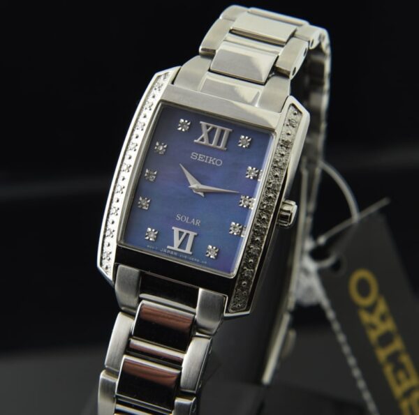 2020 Seiko 24x31.4mm Solar stainless steel ladies watch with diamond-encrusted bezel, mother-of-pearl dial, Roman numerals, and box/papers.