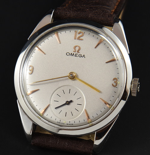 1959 Omega 34.5mm stainless steel watch with original restored dial, gold-toned Arabic markers, and caliber 267 manual winding movement.