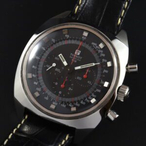 Tissot T12 stainless steel chronograph watch with original winding crown, black dial, red accents, and Lemania 1281 manual winding movement.