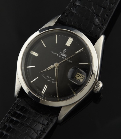 1960s Tudor stainless steel watch with original small-rose emblem, black gilt dial, hands, and cleaned, accurate automatic winding movement.