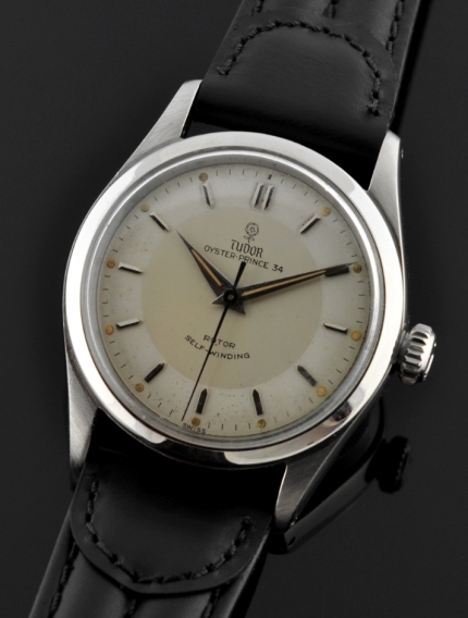 1950s Tudor Oyster Tuxedo stainless steel watch with original bullseye dial, small-rose emblem, and caliber 390 automatic winding movement.