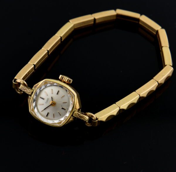 1950s Tudor gold-filled ladies cocktail watch with original glass crystal, beveled edges, signed case, and manual winding Rolex movement.