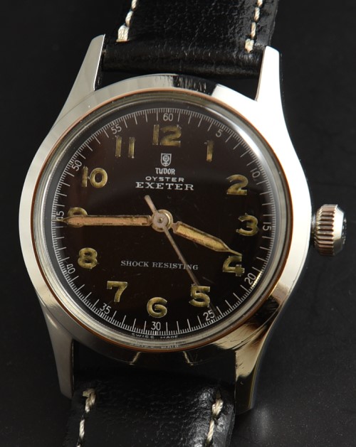 Tudor 31mm Oyster Exeter stainless steel watch with original black dial, pencil hands, Arabic numerals, and cleaned manual winding movement.