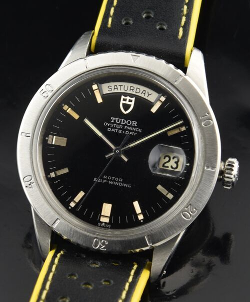 1970s Tudor Jumbo Oyster Prince Day/Date stainless steel watch with original Rolex case, black dial, baton markers, and automatic movement.