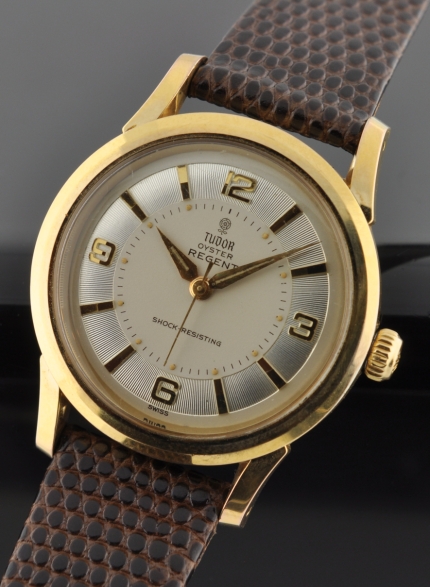 1950s Tudor Oyster Regent gold-plated watch with original case, beveled bezel, Explorer dial, Rolex winding crown, and manual movement.