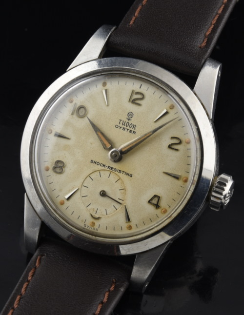 1950s Tudor 32mm stainless steel watch with original eggshell-patina small rose dial, hands, unpolished case, and manual winding movement.