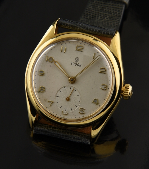 1950s Tudor gold-plated-steel watch with original small-rose dial, Arabic numerals, Rolex Oyster crown, and cleaned manual winding movement.