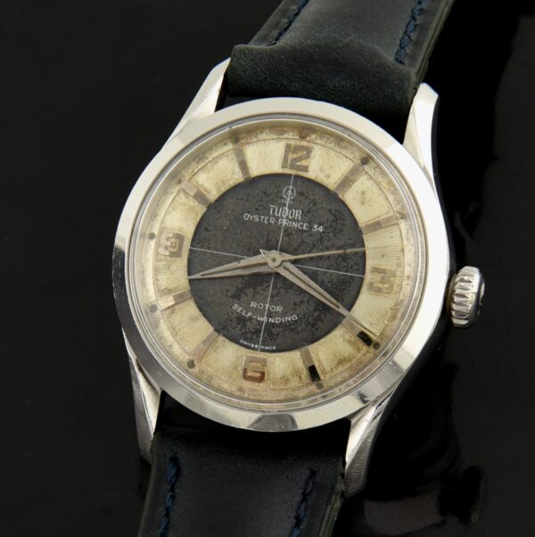 1955 Tudor 34mm Tuxedo stainless steel watch with original Explorer-style dial, Brevet Rolex crown, subtle patina, and caliber 390 movement.