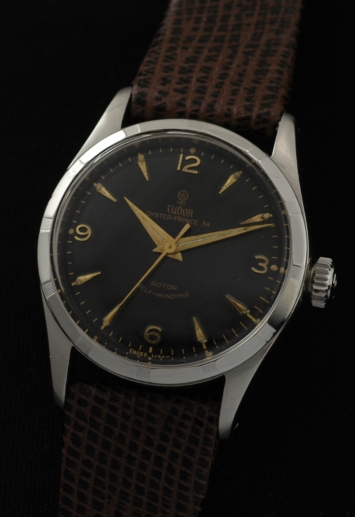 1950s Tudor Oyster-Prince 34 stainless steel watch with original jet-black dial, curved gold gilt print, rose logo, and raised markers.