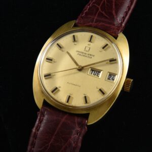 1960s Universal Geneve gold-plated watch with original case, steel back, dial, hands, day/date feature, and micro-rotor automatic movement.
