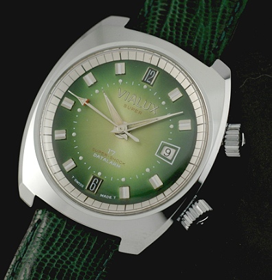 1970s Vialux Super stainless steel alarm watch with original case, emerald-green dial, eccentric date aperture, and manual winding movement.