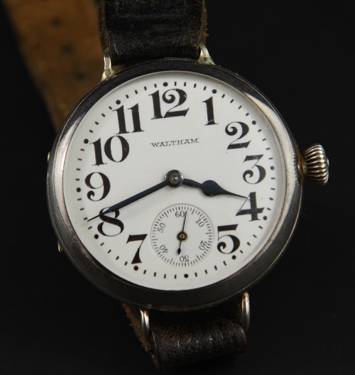 1918 Waltham 32.5mm sterling silver trench watch with original hinged case, enamel dial, winding crown, and cleaned manual winding movement.