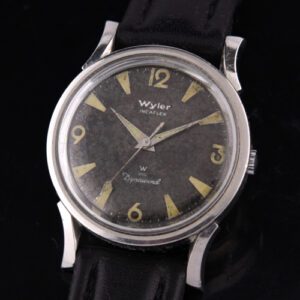 1950s Wyler Incaflex Dynawind stainless steel watch with original extended lugs, sword hands, aged black dial, and ETA automatic movement.