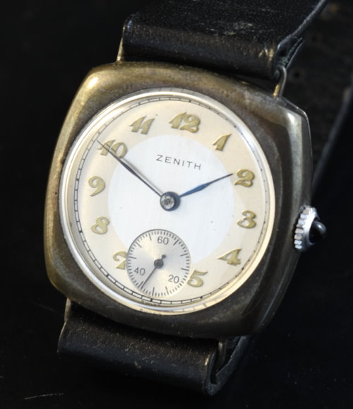 1930s Zenith 31mm sterling-silver watch with original cushion-shaped case, restored two-tone dial, and cleaned manual winding movement.